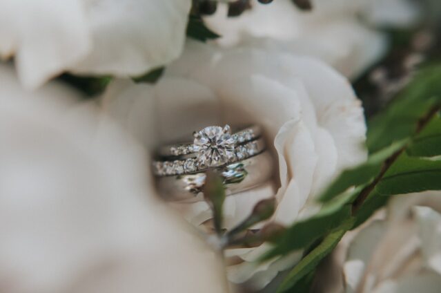 diamond ring stacked on silver wedding ring