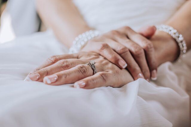 bride wearing ring and pearl bracelet