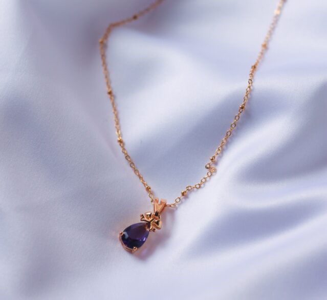 purple pendant on rose gold chain