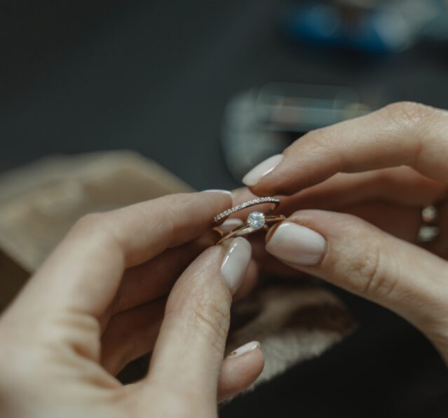 jeweller holding engagement and wedding ring