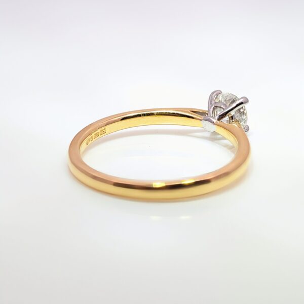 This classic four-claw 0.50ct Round Brilliant Cut Diamond is set in a 18ct Yellow and White Gold band. G Colour. SI1 Clarity. GIA Certificated.