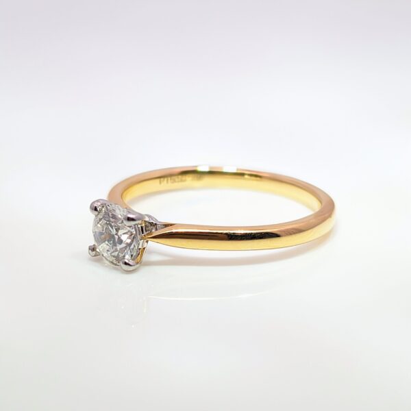 This classic four-claw 0.50ct Round Brilliant Cut Diamond is set in a 18ct Yellow and White Gold band. G Colour. SI1 Clarity. GIA Certificated.