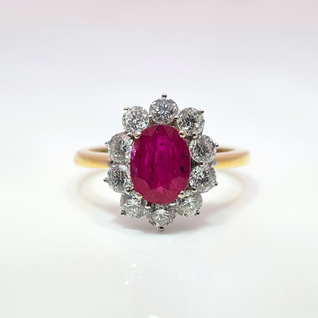 large ruby & diamond oval halo ring in 18ct yellow gold