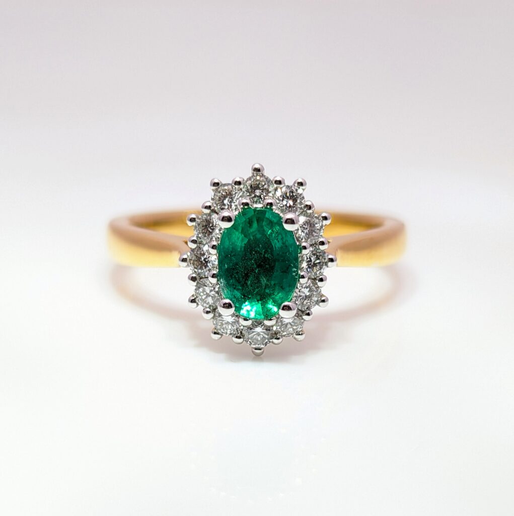 emerald & diamond oval halo ring in 18ct yellow gold