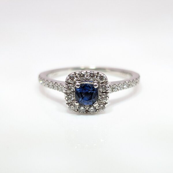 Our Pre-Loved Cushion Cut Sapphire and Diamond Halo Ring is set in a beautiful 14ct White Gold
