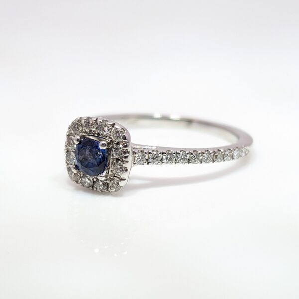 Our Pre-Loved Cushion Cut Sapphire and Diamond Halo Ring is set in a beautiful 14ct White Gold.