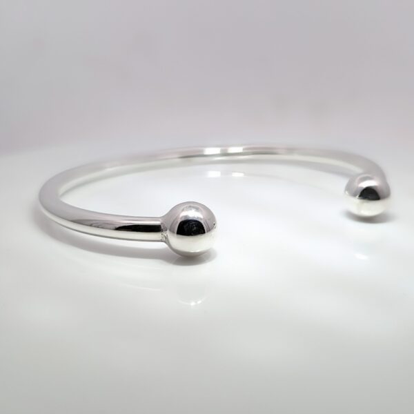 An iconic classic - the torque bangle has been worn for centuries. Our Silver Mens Solid Torque Bangle weighs 33.88gms.