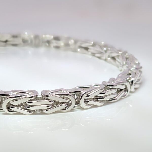 Discover our Mens Heavy Sterling Silver Byzantine Bracelet that weighs 29.6 grams. Crafted from high-quality sterling silver, it features a classic Byzantine weave pattern, known for its intricate interlocking links that create a stunning, textured design.