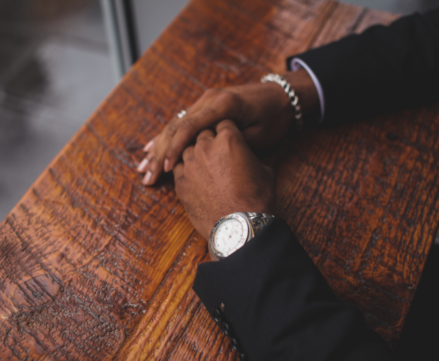 man wearing watch and silver bracelet