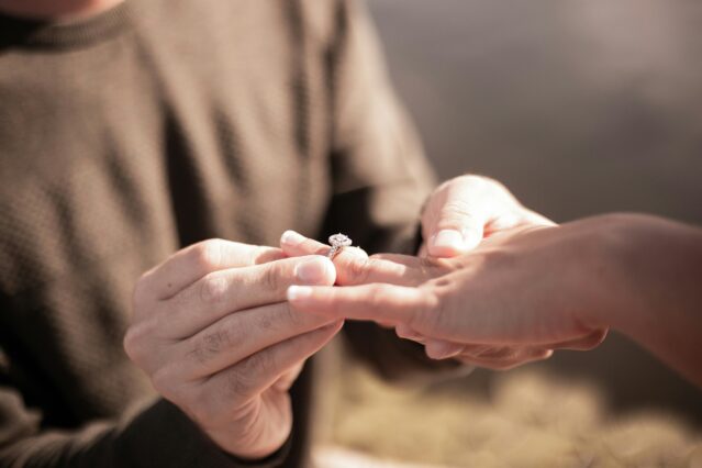 Man proposing to his partner with engagement ring