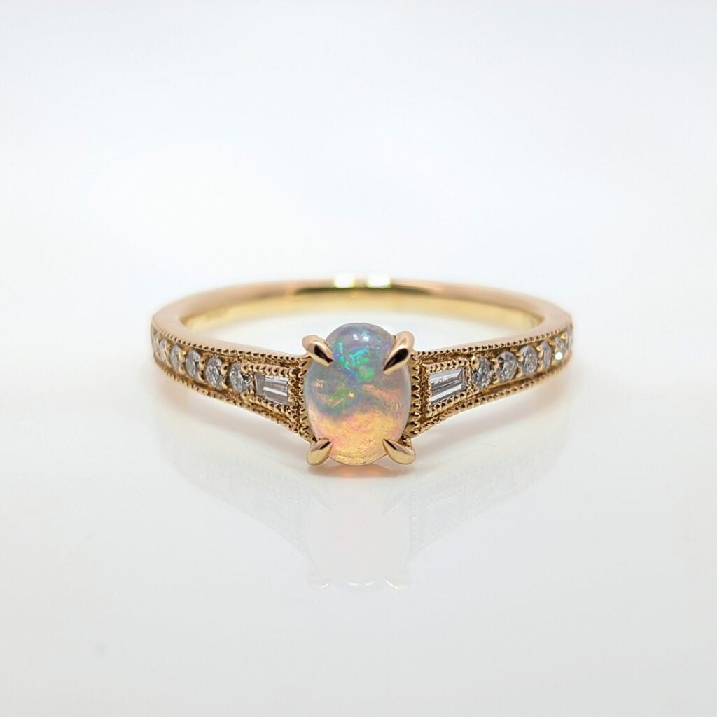 opal ring with diamond set shoulders in 18ct yellow gold