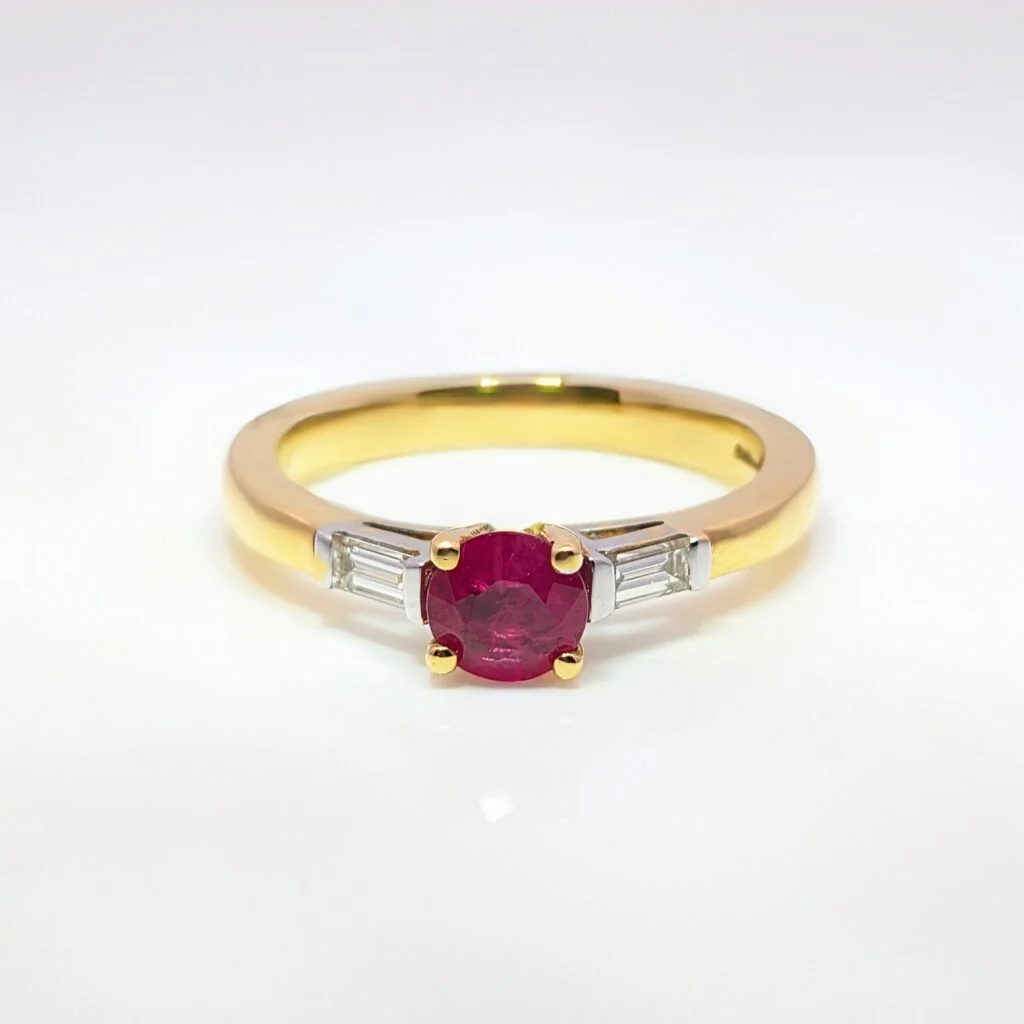 ruby ring with diamond baguette shoulders in 18ct yellow gold