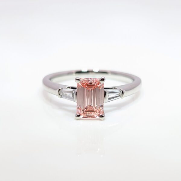 Discover our bespoke coloured lab grown diamond range. This pink diamond is set in a platinum mount with white diamond shoulders.