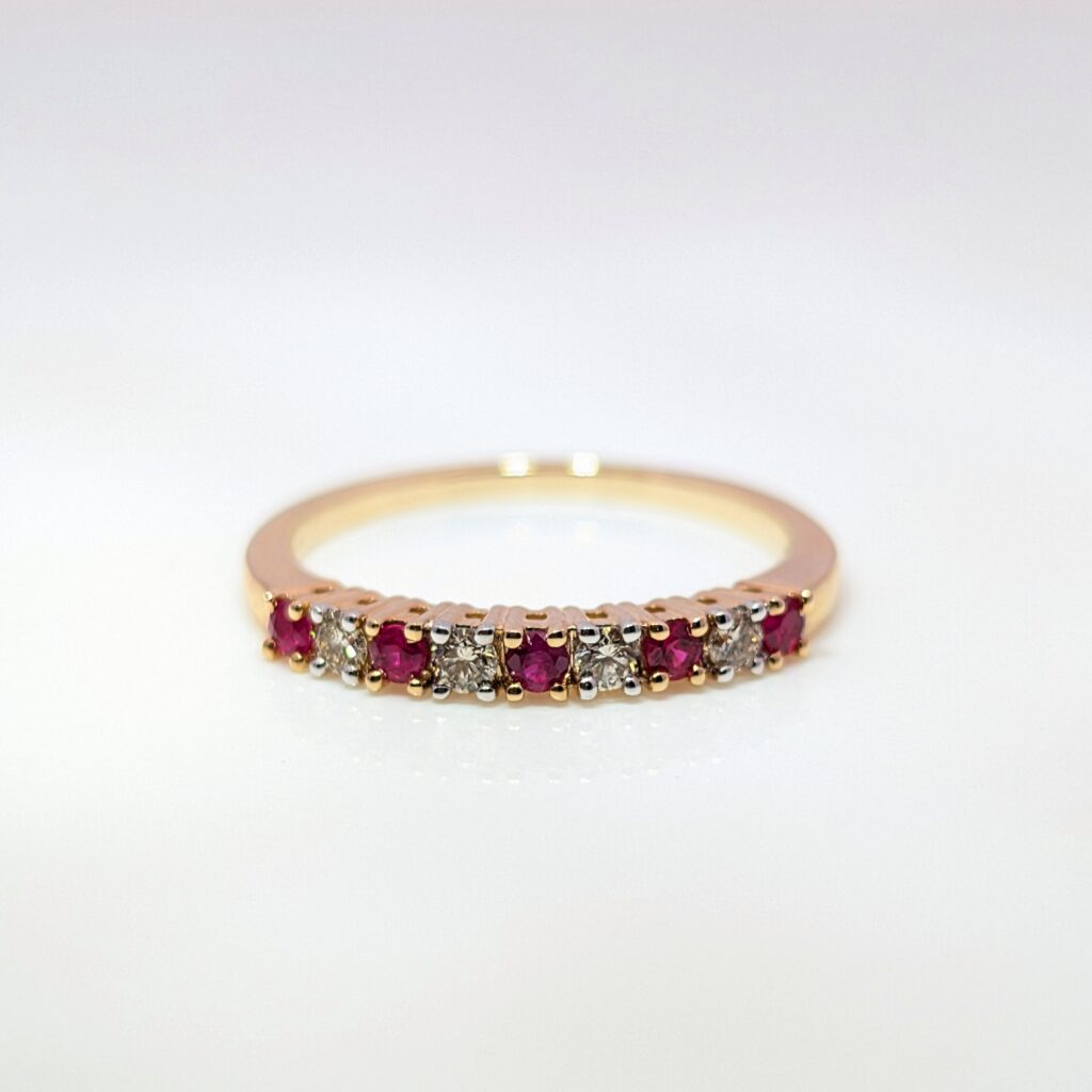 claw-set ruby & diamond half eternity ring in 9ct yellow gold