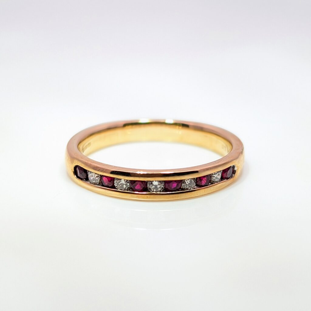 channel-set ruby & diamond half eternity ring in 9k yellow gold