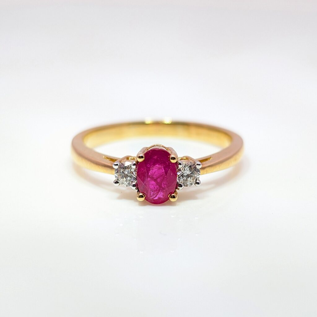 oval ruby & diamond trilogy ring in 9ct yellow gold