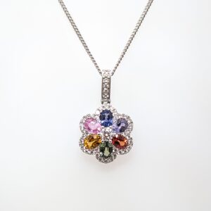 Discover our Multi-Coloured 1.27ct Sapphire and 0.35ct Diamond Floral Pendant set in 18ct White Gold. Sapphire jewellery is a timeless gift, but is especially meaningful to those with a September birthday.