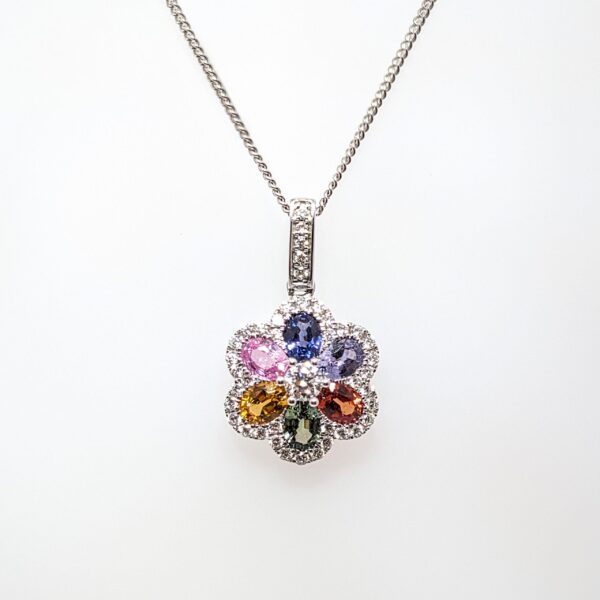 Discover our Multi-Coloured 1.27ct Sapphire and 0.35ct Diamond Floral Pendant set in 18ct White Gold. Sapphire jewellery is a timeless gift, but is especially meaningful to those with a September birthday.