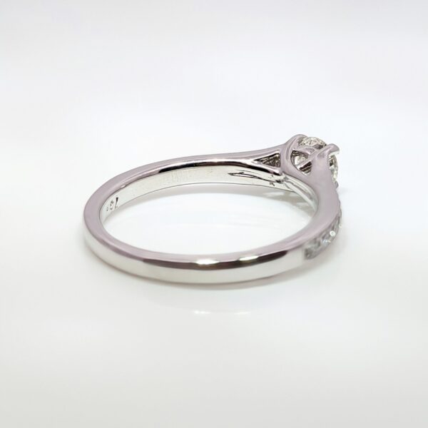 This 18ct white gold diamond engagement ring has an elegant milgrain edge encasing the shoulder stones, and a high-set centre stone making it ideal for your future wedding band.