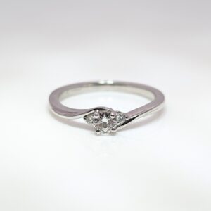 Discover our Trilogy Twist Engagement Ring 0.17ct Centre Diamond in 18ct White Gold . Celebrating the ‘past, present, and future’ symbolism, this piece makes an exceptional engagement ring or something to celebrate a special occasion.