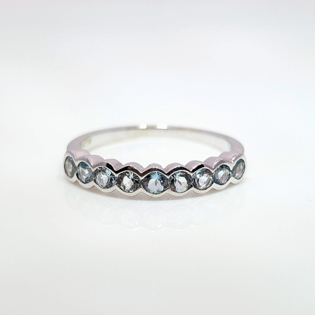 aquamarine and diamond half eternity ring in 9k white gold