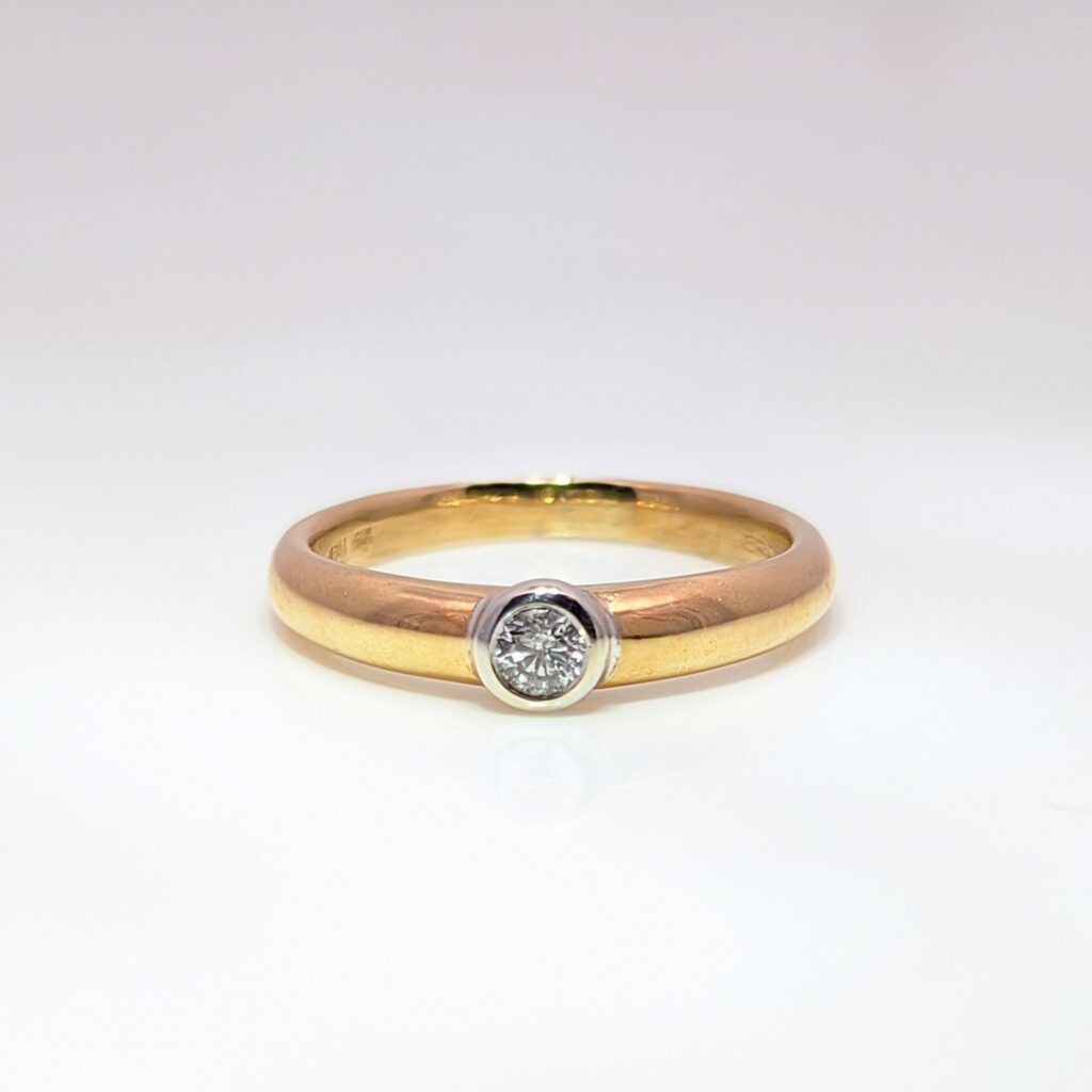Vintage pre-loved bezel-set diamond solitaire ring in 9k yellow gold