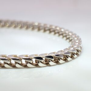 Discover our Mens Heavy Sterling Silver Franco Chain that weighs 80 grams. Crafted from high-quality sterling silver, it features a fluid four sided curb chain, known for being very tactile and feeling like an open snake chain. 30 inches in length.