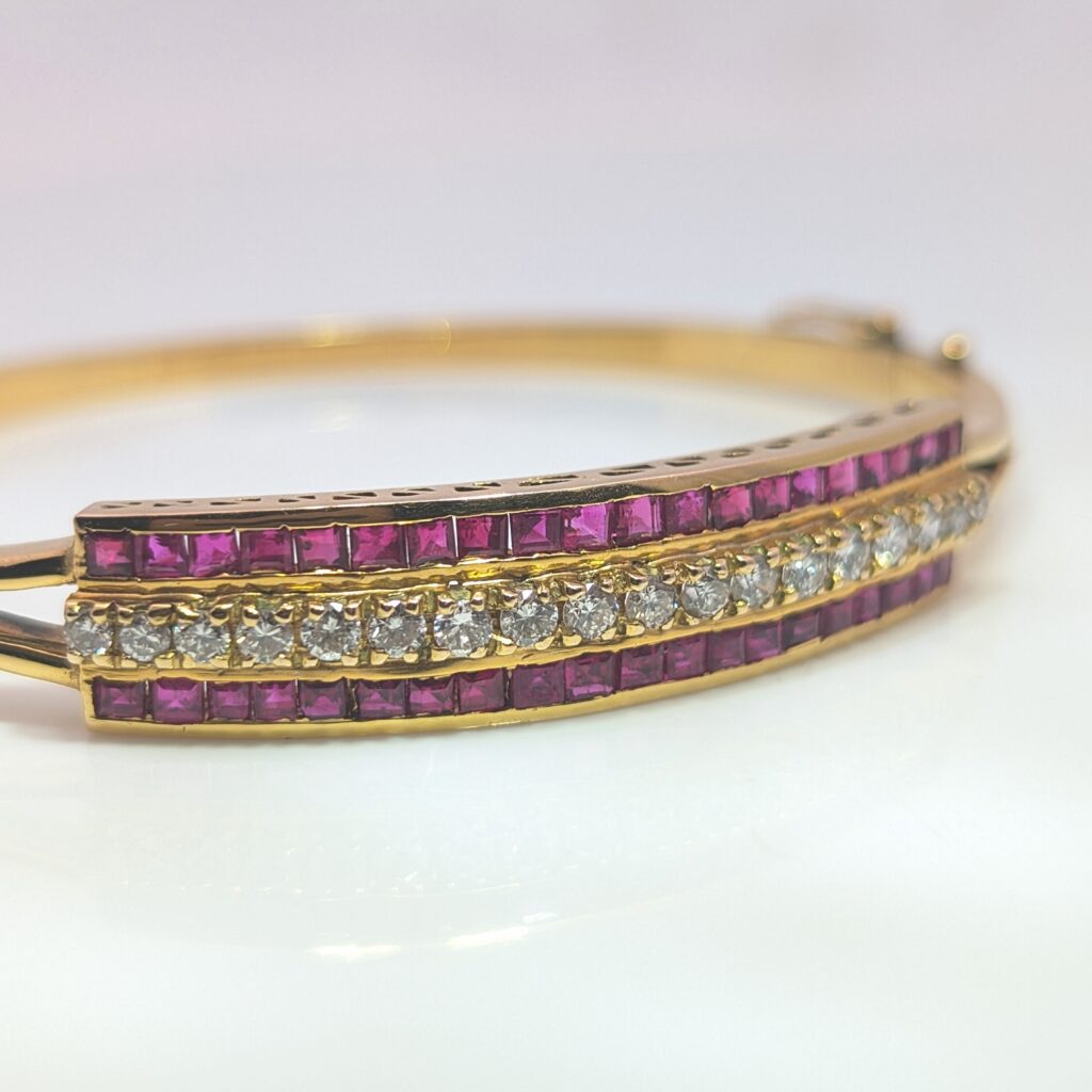 Vintage pre-loved ruby and diamond bangle in 18k yellow gold