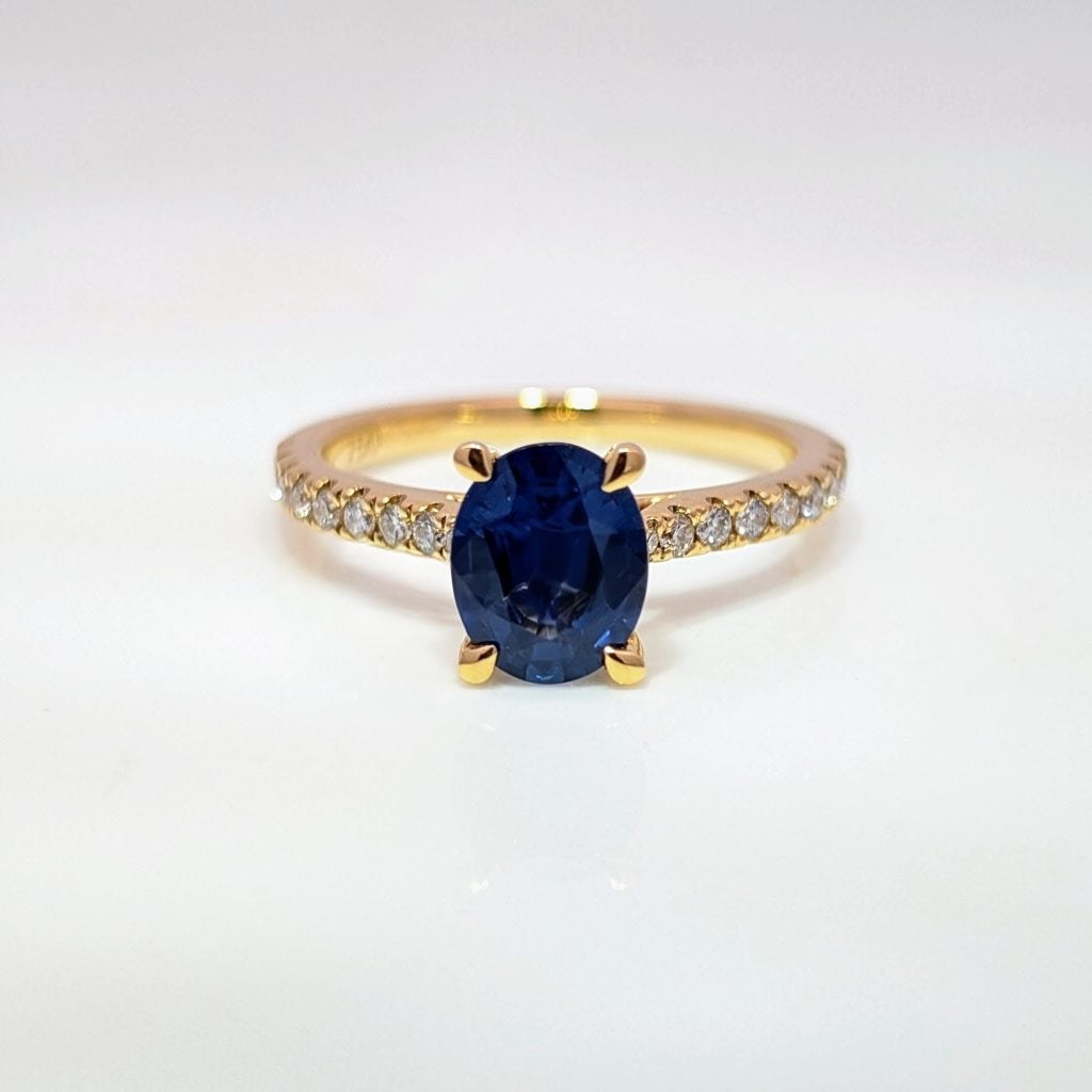 oval sapphire ring with diamond set shoulders in 18ct yellow gold