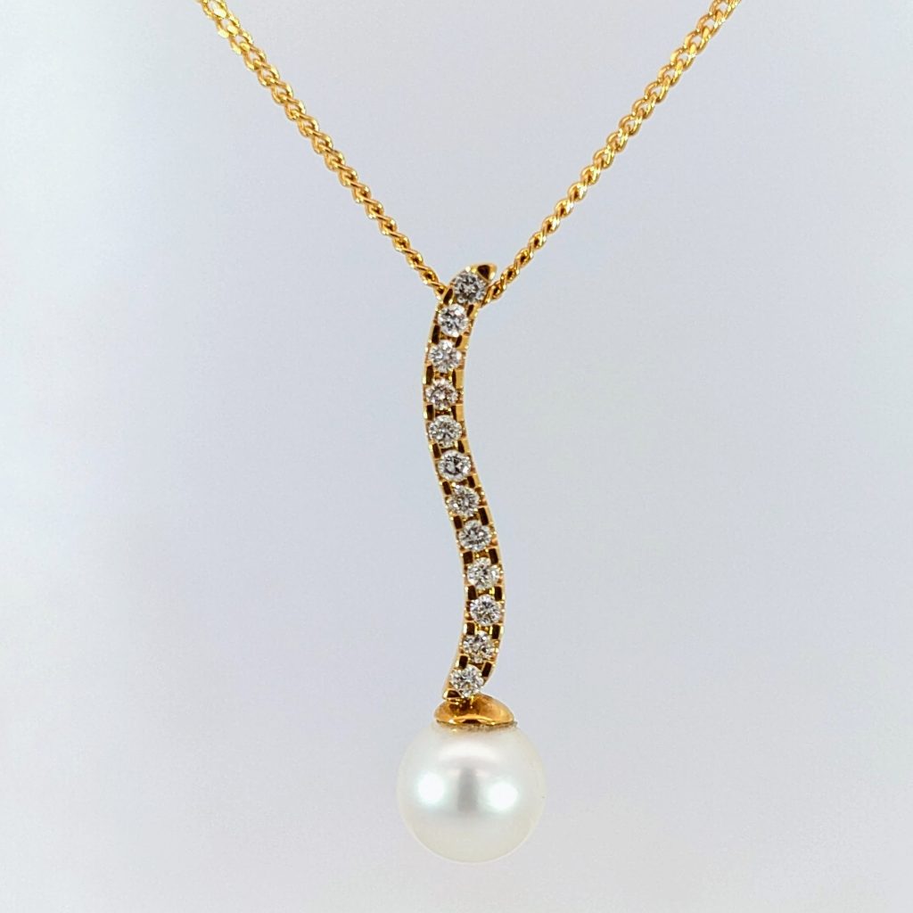 pearl & diamond wave drop pendant in 18ct yellow gold