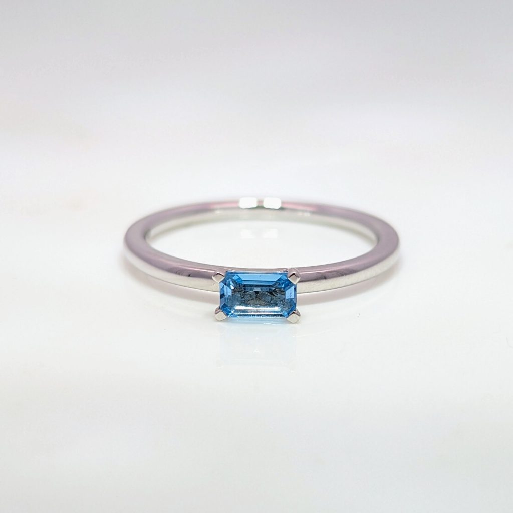 blue topaz emerald-cut ring in 18ct white gold