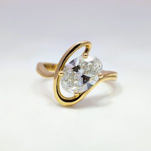 Find a shape that celebrates your love with our range of unique engagement rings. New in! Our 2ct Oval Lab-Grown Diamond Swirl Engagement Ring in 18k Yellow Gold. (Part of a set)