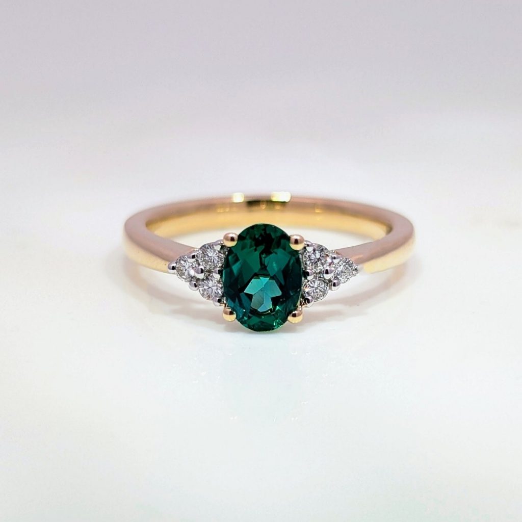 lab grown oval emerald & diamond engagement ring in 9k yellow gold