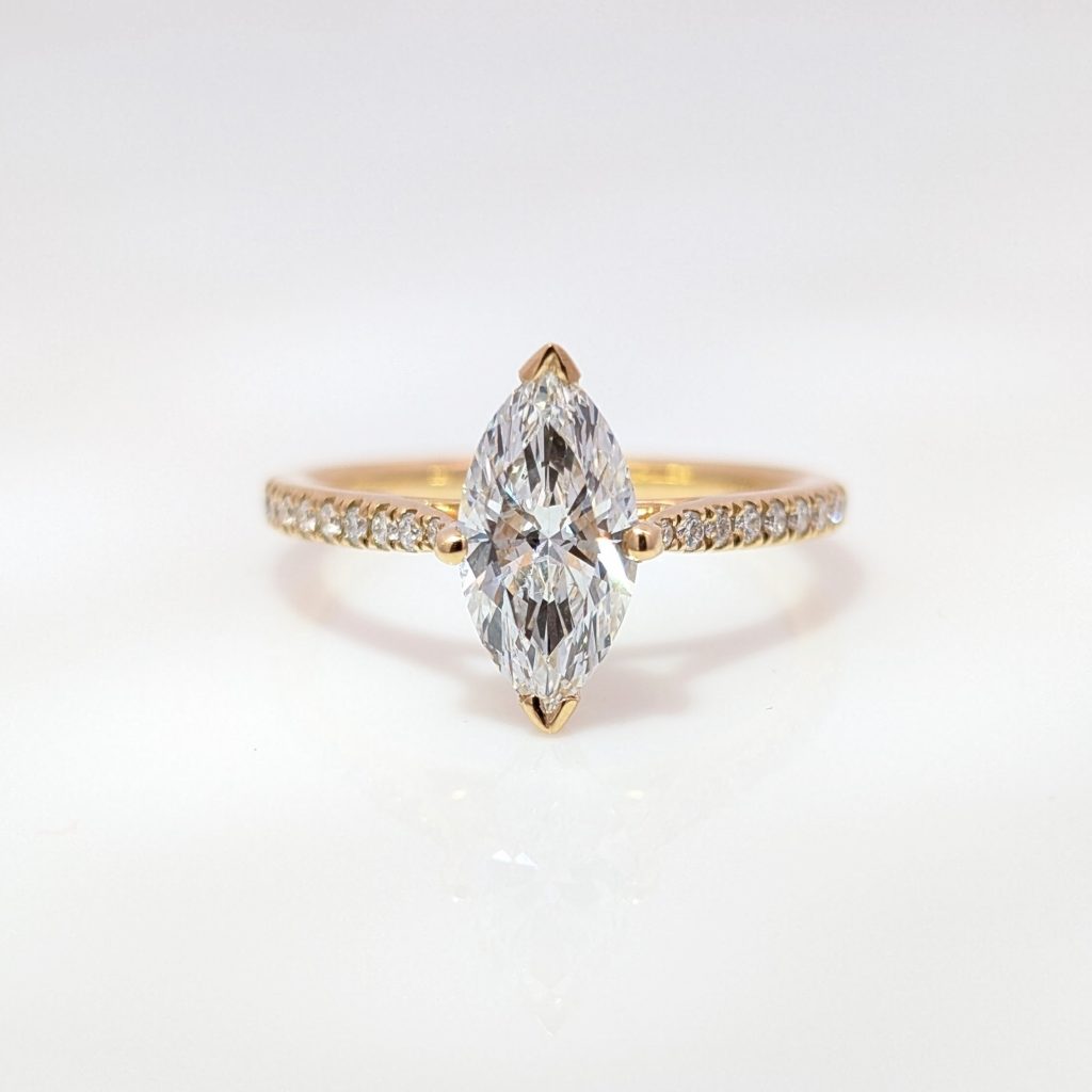 lab grown marquise diamond engagement ring in 18k yellow gold with diamond shoulders