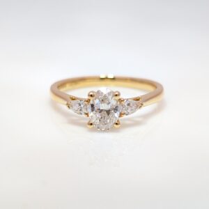 three stone oval & pear diamond engagement ring in 18k yellow gold