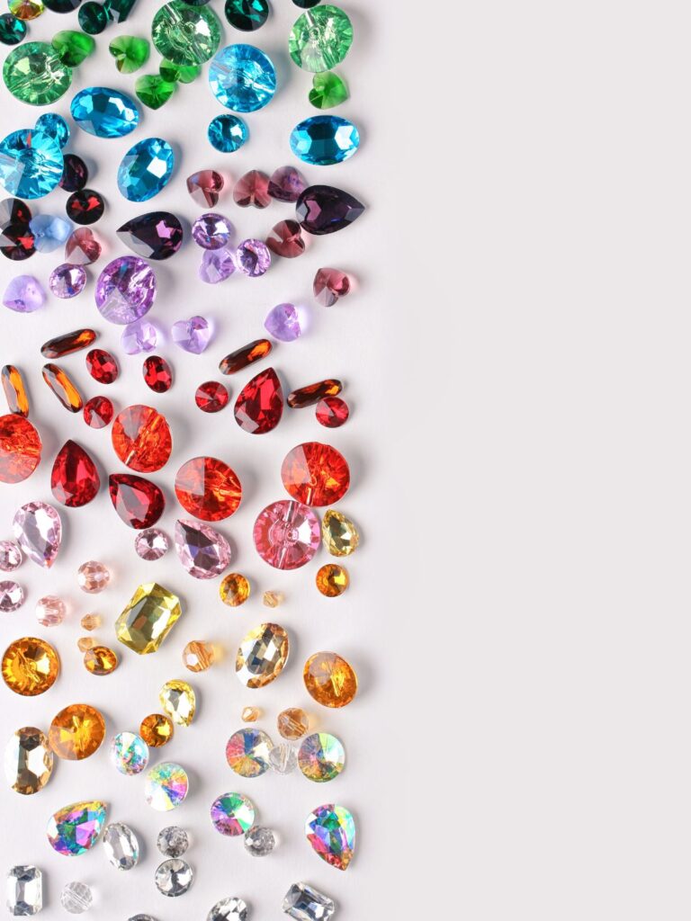 Complete Birthstone Guide - scattered gems in a variety of colours
